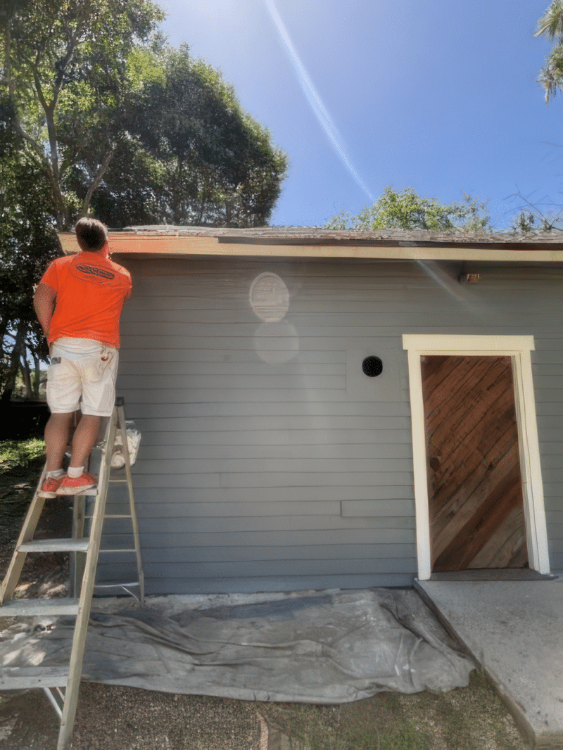 Trombley painter working an exterior from a ladder